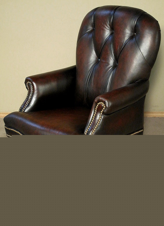 Upholstered brown leather executive office arm chair